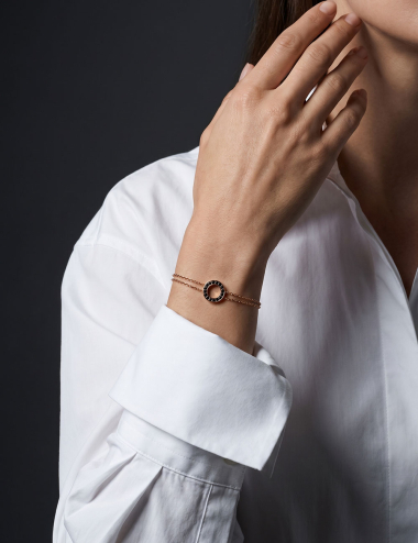 Cercle women’s circle bracelet in 18k rose gold with black diamonds worn on the wrist.