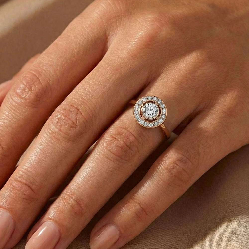 Rose gold and white diamond halo ring worn by a woman.