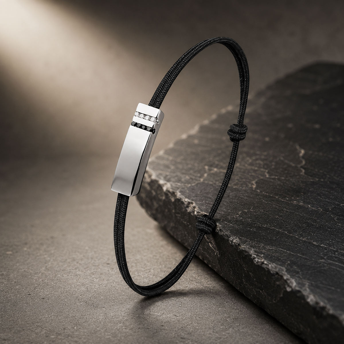 Dynamik men’s bracelet in 18k white gold with white and black diamonds on a black cotton cord
