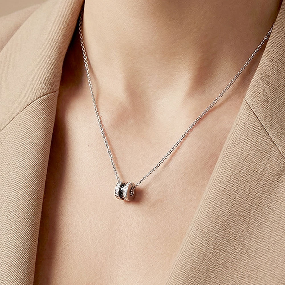 
Women’s Scroll in Love pendant in 18k white gold, set with white and black diamonds.